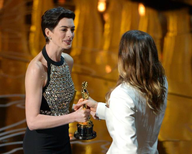 Anne Hathaway, left, presents Jared Leto with the award for best actor in a supporting role for Dallas Buyers Club during the Oscars at the Dolby Theatre on Sunday, March 2, 2014, in Los Angeles.  (Photo by John Shearer/Invision/AP)